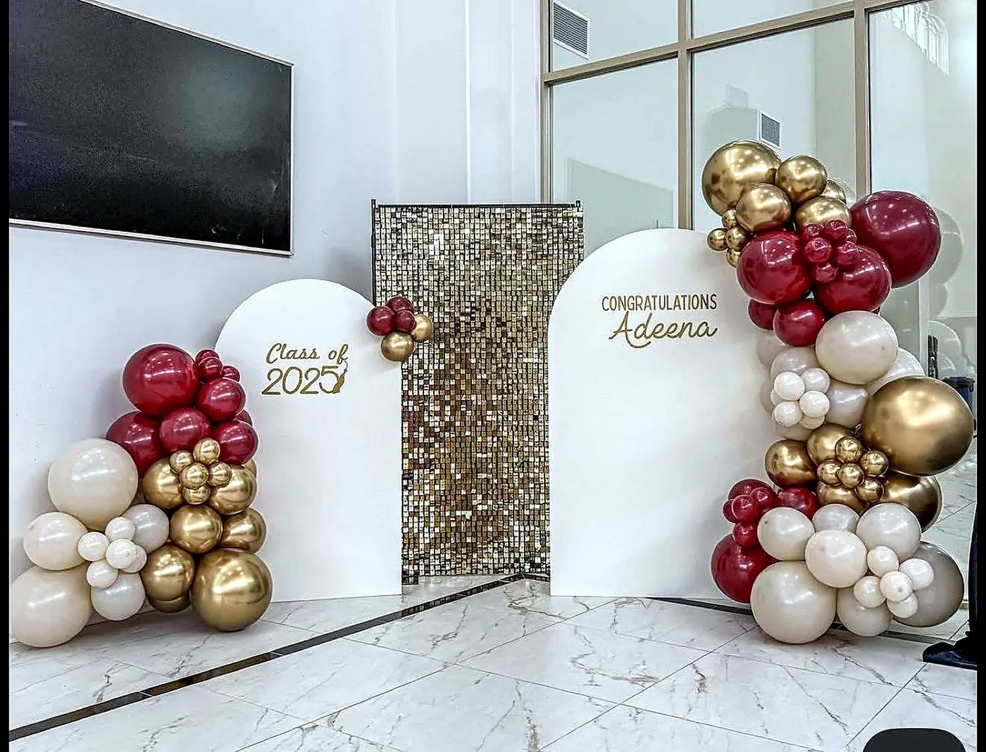 Graduation balloon garland and gold sequin arch backdrop with Class of 2025 signage by Bsquare Events