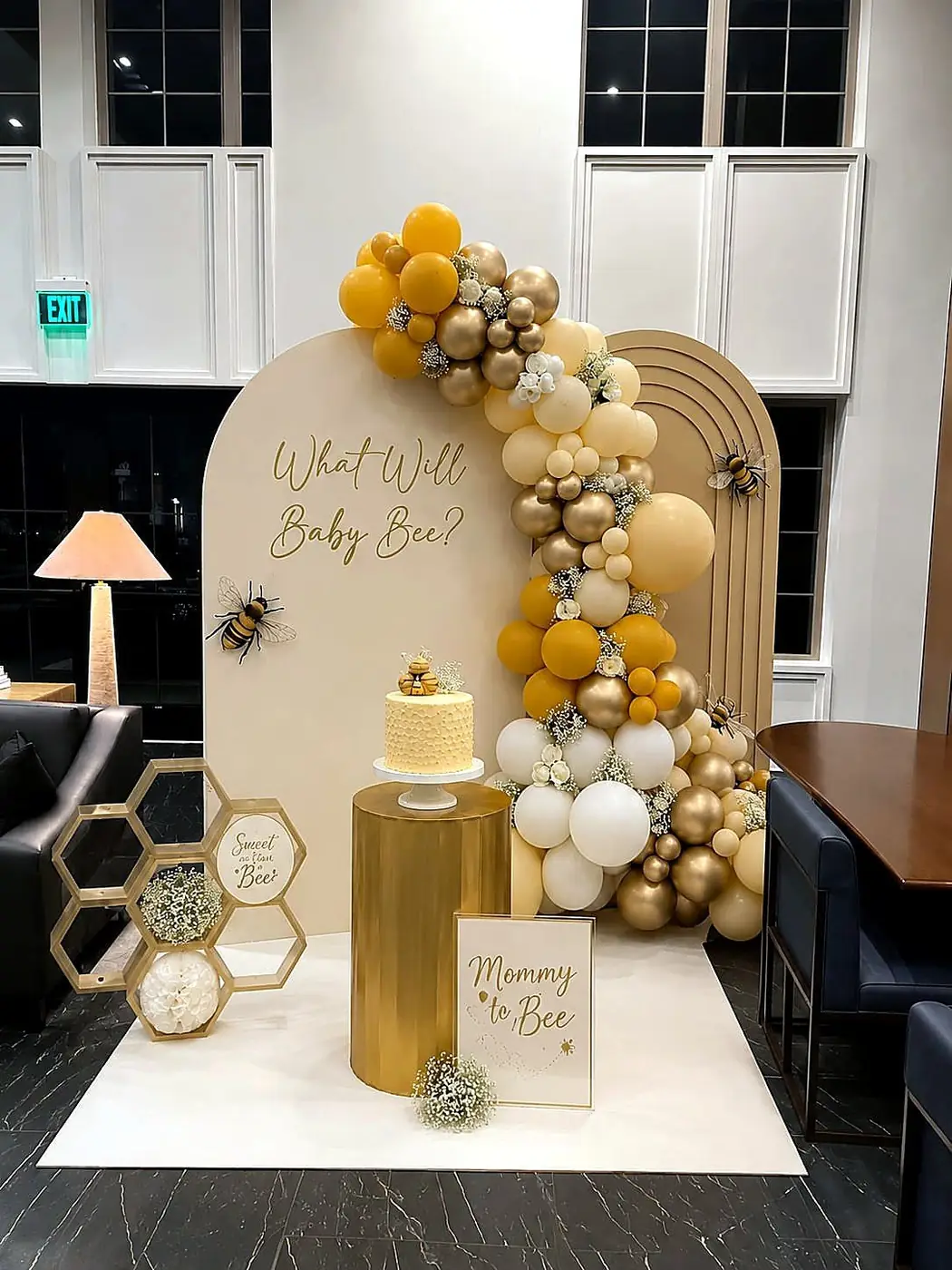 Gender reveal baby shower arch in gold, mustard and ivory balloons with bee details and honeycomb cake table by Bsquare Events
